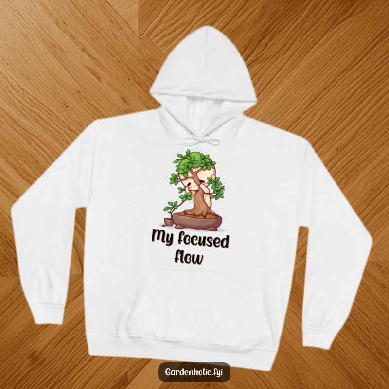 Funny hoodie featuring a playful character intensely focused on pruning a miniature bonsai tree, perfect for cozy contemplation.