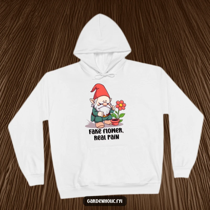 Funny hoodie: A grumpy garden gnome looking utterly fed up while watering a clearly artificial, plastic flower, a scene of pure comedic despair.