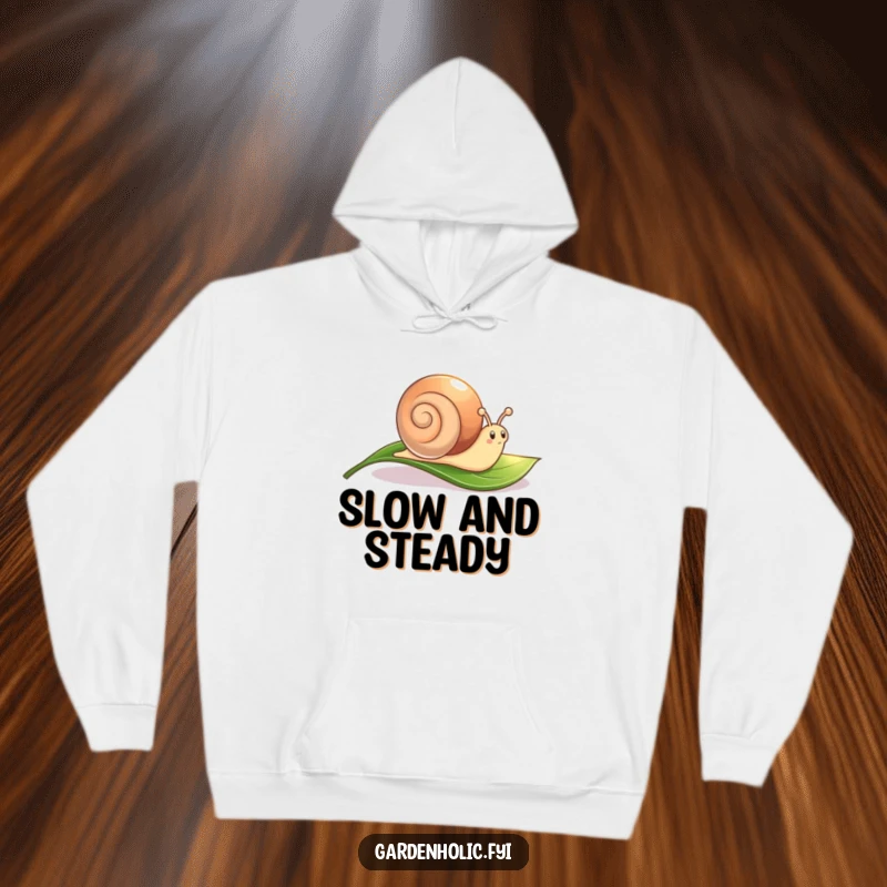 Funny Snail Hoodie: A cute character leaving a shimmering trail across a leaf, cozy and charming.